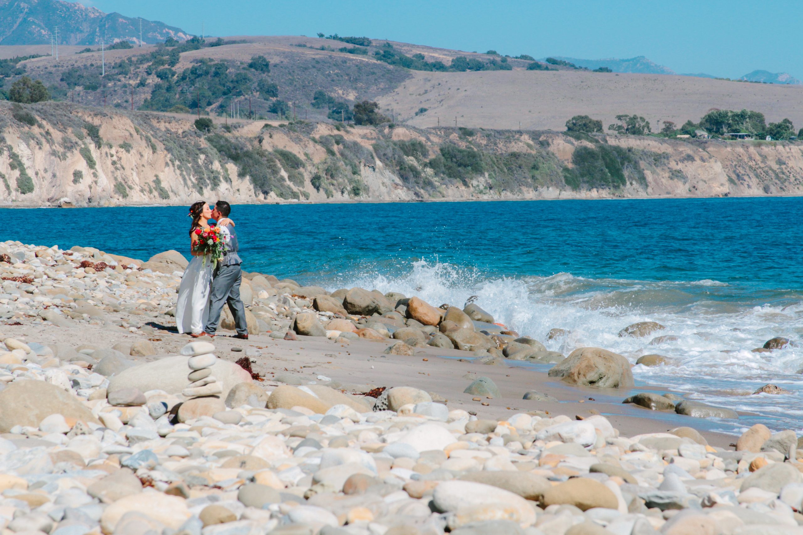 santa barbara wedding photographer colorful wedding at the beach bride and groom at the edge of the water