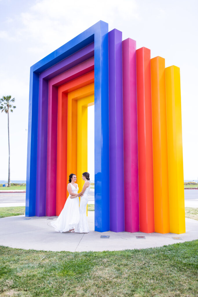 lgbtq+ wedding photographer two brides in white wedding dresses at the rainbow gate in santa barbara. lesbian wedding