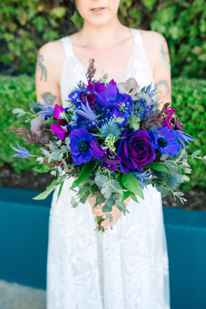 bride holding her unique purple bouquet