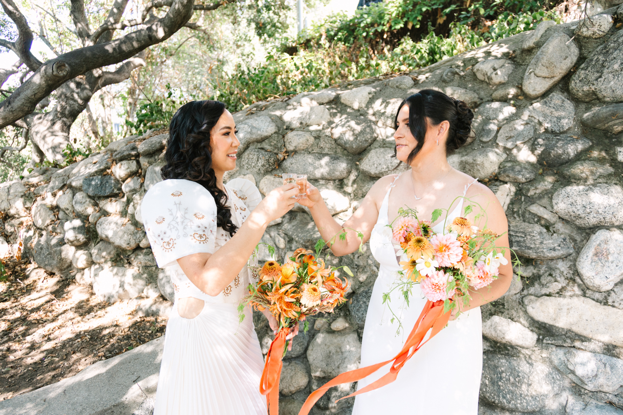 how to feel comfortable in front of the camera on your wedding day. Brides cheersing after their wedding