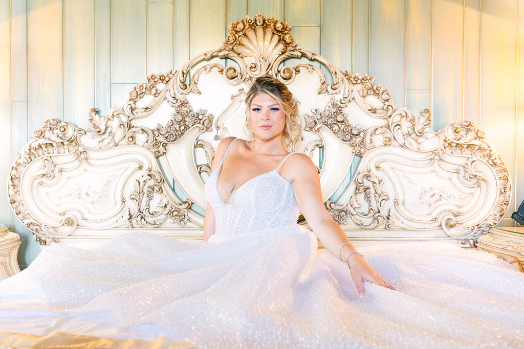 madonna inn wedding photographer, bride in her sparkly wedding dress laying back on her bed