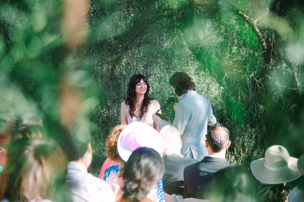 Audubon Center at Debs Park wedding, Forest ceremony under trees at Audubon Center at Debs Park with guests seated.