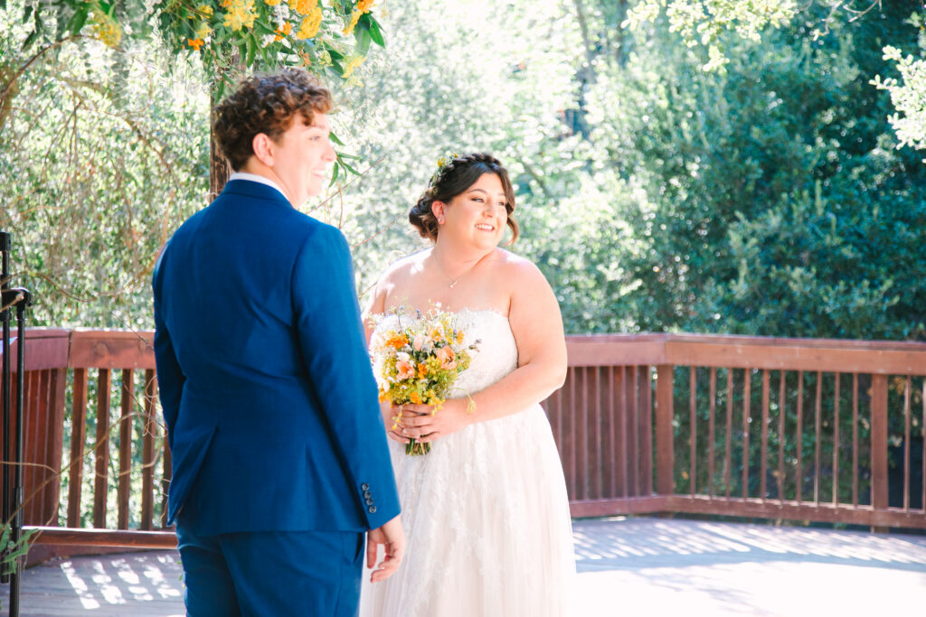 Lesbian Wedding Ceremony, one bride in a blue suit, one bride in a white dress, 1909 Wedding Venue 
