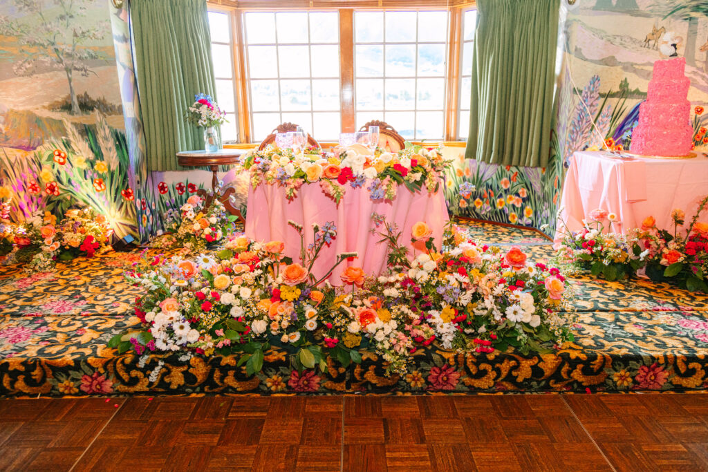 Madonna Inn Wedding Reception sweetheart table with lots of flowers