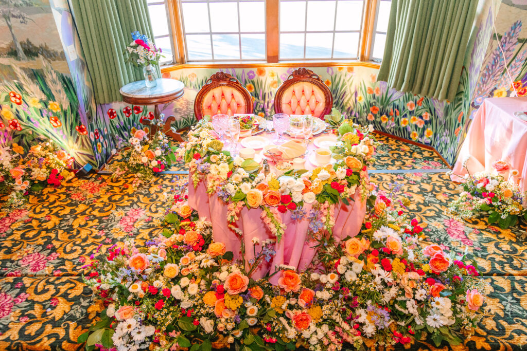 Madonna Inn Wedding Reception sweetheart table with lots of flowers