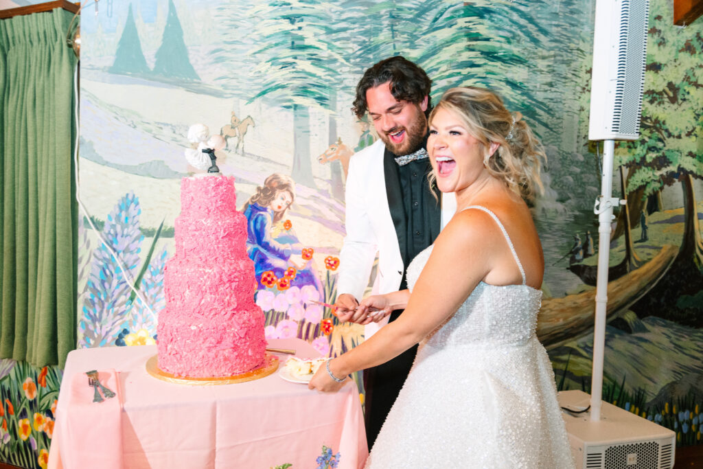 Madonna Inn Wedding bride and groom cutting their pink wedding cake.