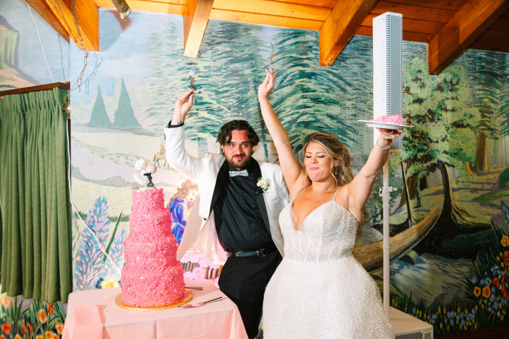 Madonna Inn Wedding bride and groom cutting their pink wedding cake.