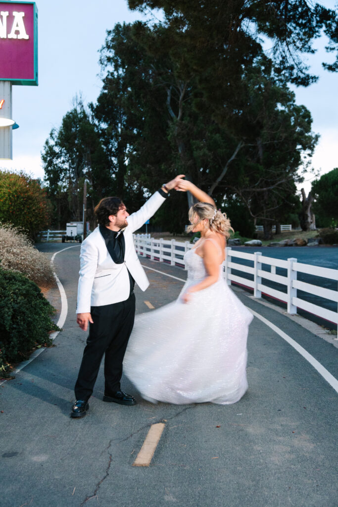 Madonna Inn Wedding Photographer Portraits with Bride and Groom by the neon sign.