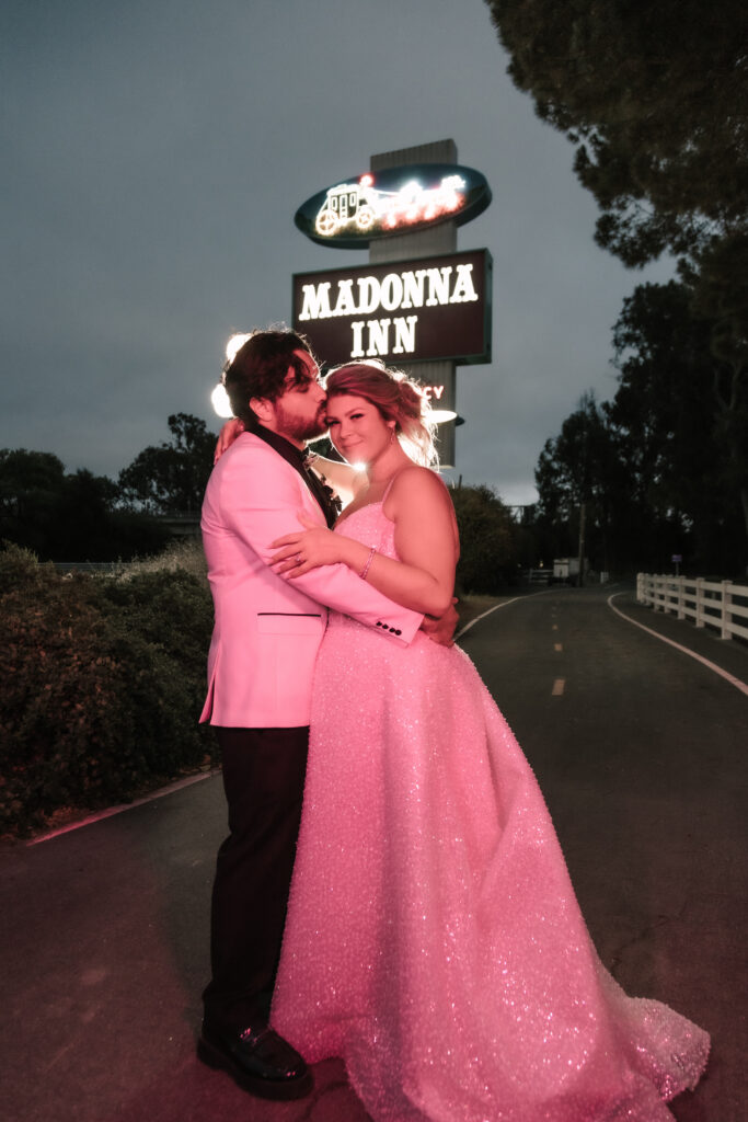 Madonna Inn Wedding Photographer Portraits with Bride and Groom by the neon sign.