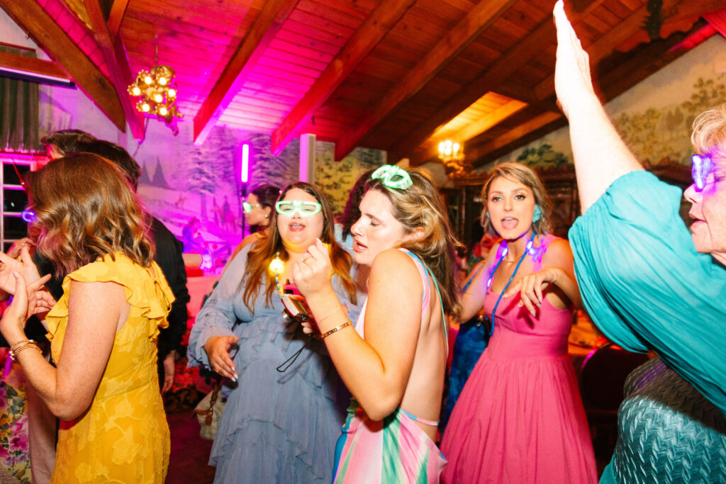 Madonna Inn Wedding Reception, people in bright colors dancing and having fun on the dance floor.
