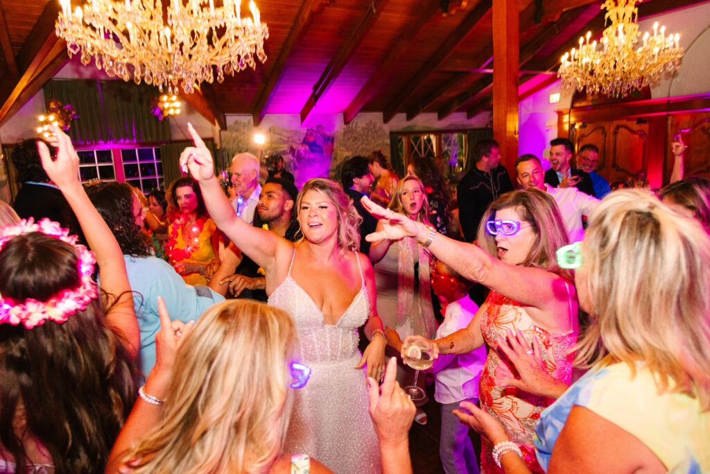 Madonna Inn Wedding Reception, people in bright colors dancing and having fun on the dance floor.
