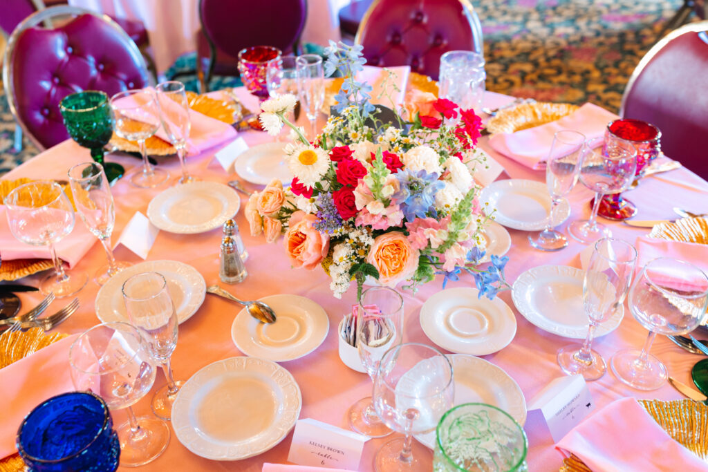 Madonna Inn Wedding reception room with pink linens and colorful flowers