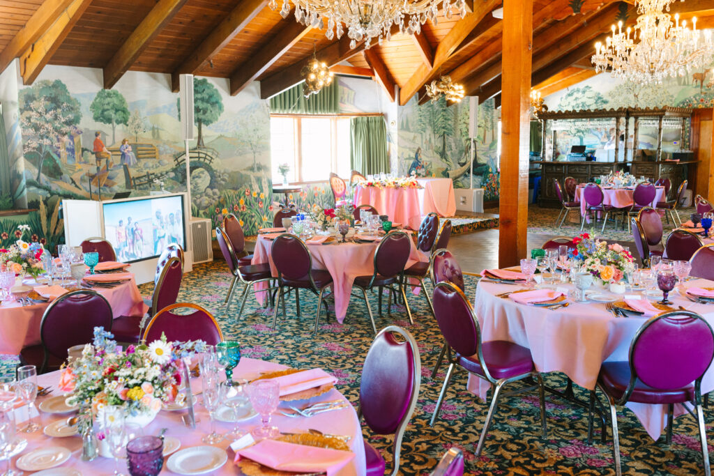 Madonna Inn Wedding reception room with pink linens and colorful flowers