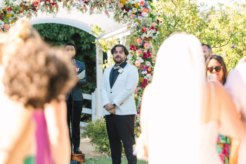 Madonna Inn Wedding ceremony in the secret garden, groom seeing his bride for the first time.