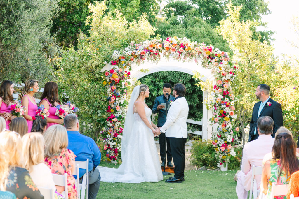 Madonna Inn Wedding ceremony in the secret garden with floral arch 